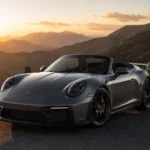 بورشه 911 GT3 2027 المكشوفة أثناء القيادة على طريق جبلي متعرج وقت الغروب